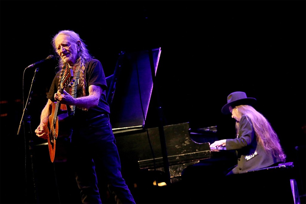 Willie Nelson plays guitar while his sister, Bobby, plays the piano.