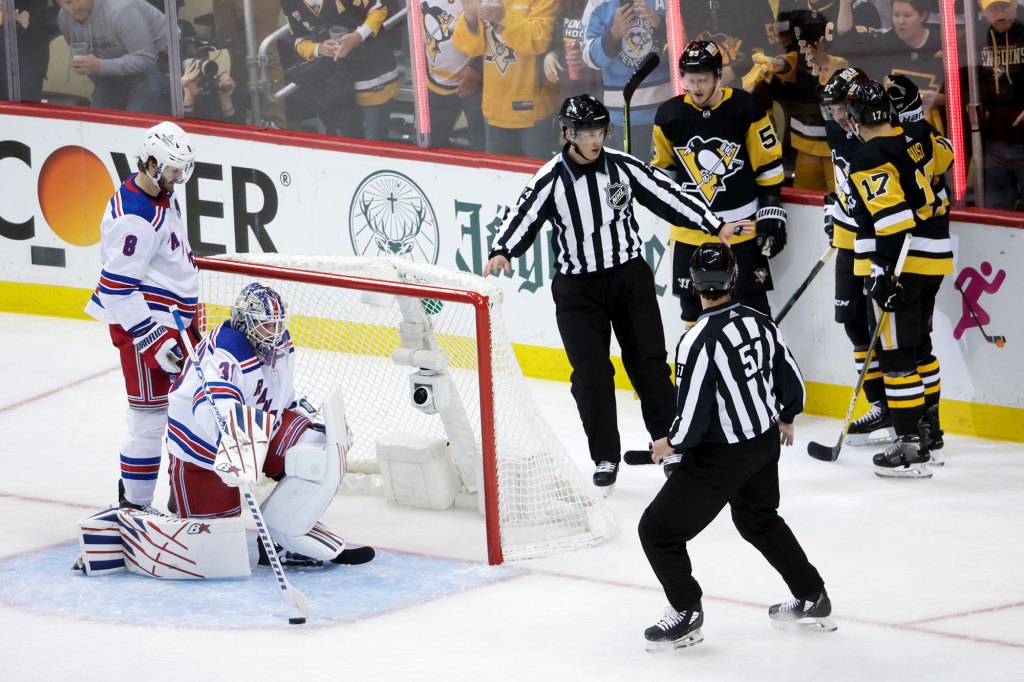 Sidney Crosby #87 of the Pittsburgh Penguins celebrates with his teammates after scoring a pass by Igor Shesterkin #31 of the New York Rangers