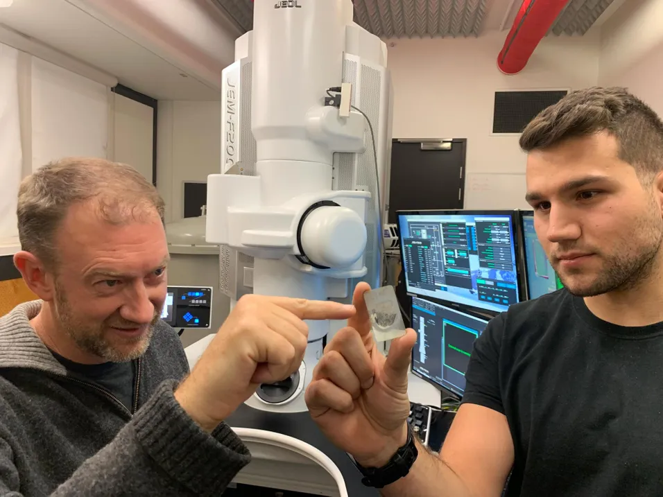 Scientists with a urelite meteorite sample